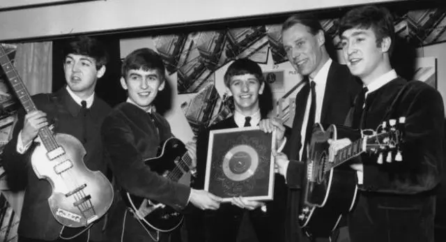 Martin, pictured with the Beatles in 1963, was knighted in 1996