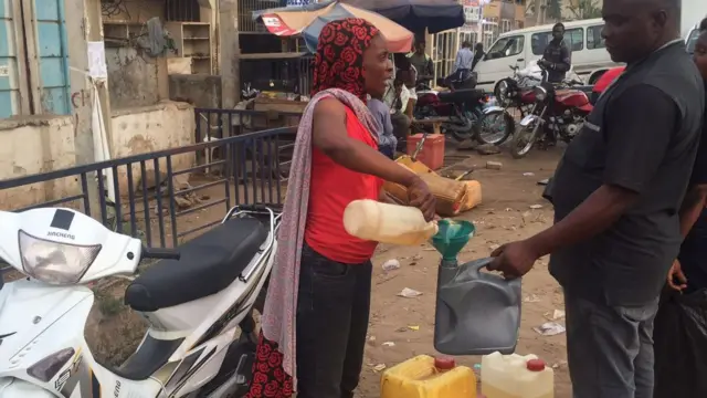 Female petrol vendor in Abuja, Nigeria