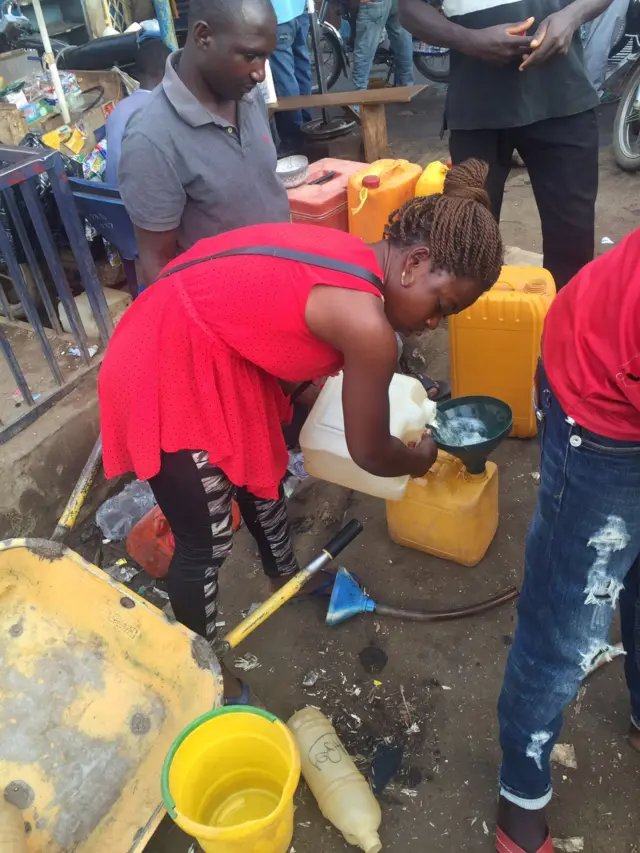 Mary, a female petrol vendor in Abuja, Nigeria