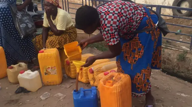 A female petrol vendor in Abuja, Nigeria