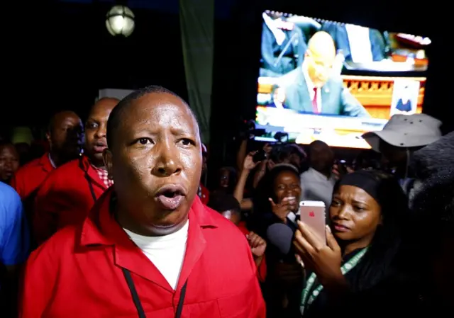 Economic Freedom Fighters (EFF) leader Julius Malema speaks to journalists after being ordered to leave the parliamentary chamber during President Jacob Zuma's State of the Nation address in Cape Town, February 11, 2016