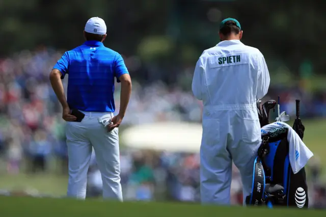 Jordan Spieth looks on