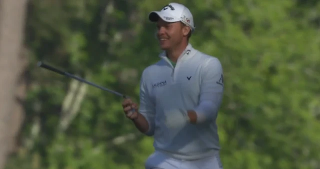 Danny Willett smiles on course