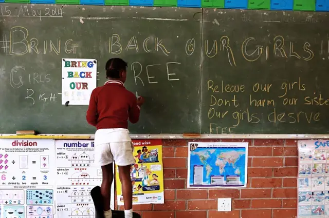 young South African student at a primary school in Durban writes a message on a blackboard during a 'BringBackOurGirls' school project calling for the immediate release of over 200 abducted Nigerian school girls, on May 15, 2014