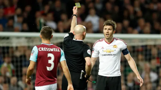 Manchester United's Michael Carrick gets a yellow card