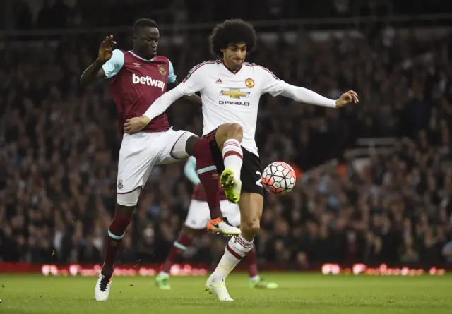 Marouane Fellaini is challenged by Cheikou Kouyate