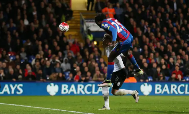 Emmanuel Adebayor heads at goal