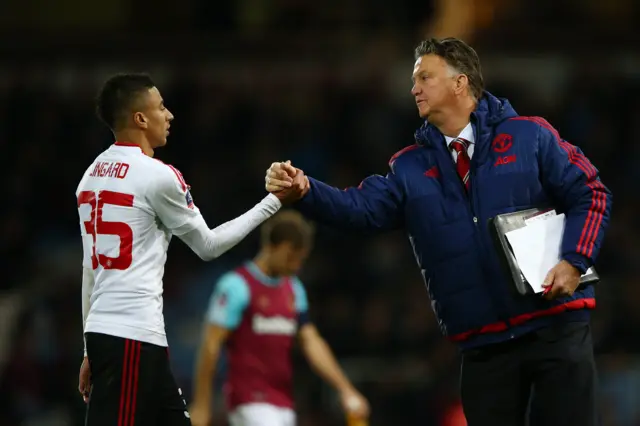 Louis van Gaal shakes hands with Jesse Lingard at full-time