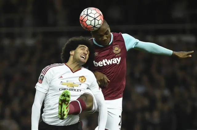 Marouane Fellaini challenges for the ball with Angelo Ogbonna