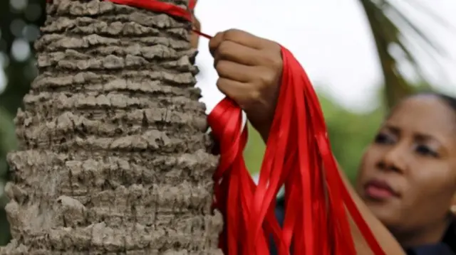 Bring Back Our Girls campaigners in Nigeria tying ribbons to remember the kidnapped girls