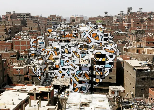 A mural painted on the walls of houses in Zaraeeb on the Mokattam Hills in eastern Cairo, Egypt