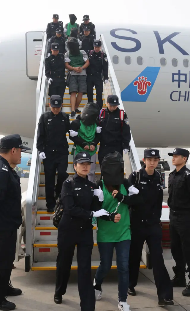 People escorted off a plane