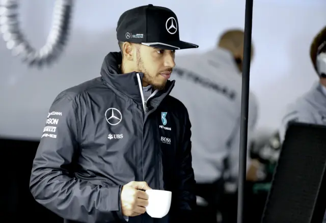 Lewis Hamilton with a mug