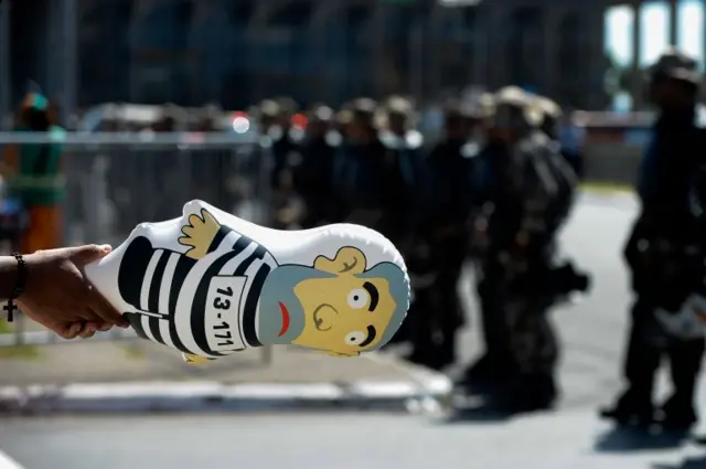 A protester waves an inflatable doll of former President Lula at a protest outside the National Congress in Brasilia, on 17 April, 2016