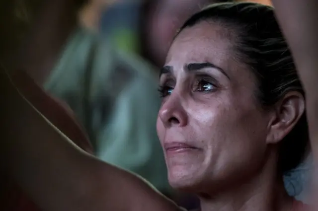 A woman follows the voting on a screen in Belo Horizonte