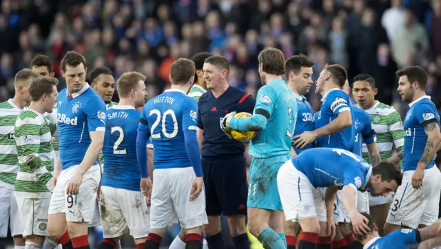 Referee Craig Thomson in the middle of a sea of Celtic and Rangers players