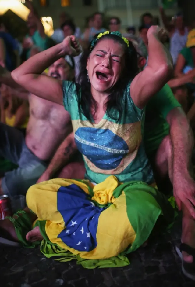 A pro-impeachment supporter dressed with Brazilian national colors cheers as a "Yes" vote is cast while watching a live television broadcast as lower house deputies cast their votes in the impeachment process of President Dilma Rousseff on April 17, 2016 in Rio de Janeiro, Brazil.