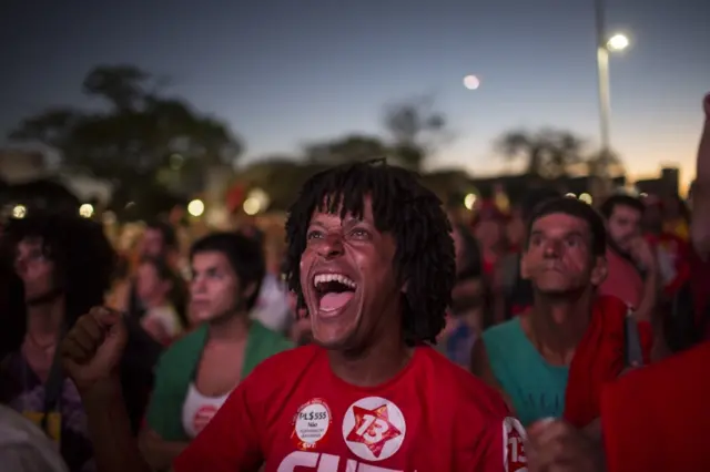 Pro-government demonstrators react as they watch the voting on a screen in Brasilia, Brazil, Sunday, April 17, 2016