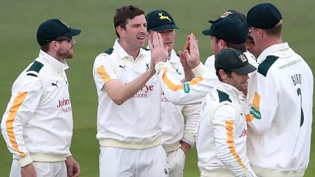 Harry Gurney celebrates taking a wicket for Notts