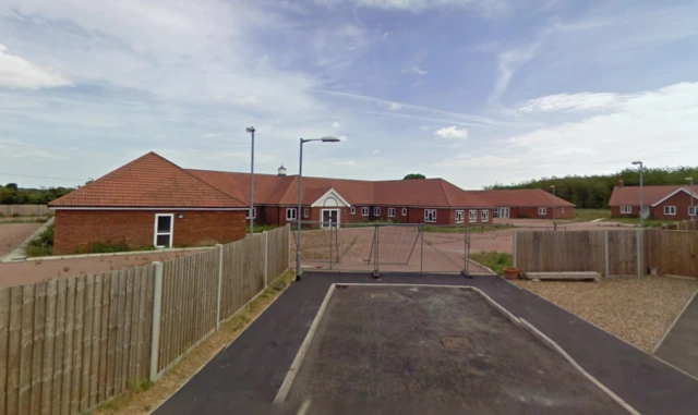 Street view of the care home, with barriers across the entrance