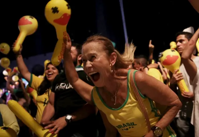 Demonstrators react as they look on at a big screen showing a session to review the request for President Dilma Rousseff"s impeachment in Brasilia, during a protest against Rousseff at Paulista Avenue in Sao Paulo, Brazil, April 17, 2016