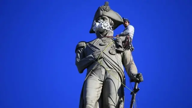 Mask on a London statue A face mask has been placed on Lord Nelsons statue in Trafalgar Square by