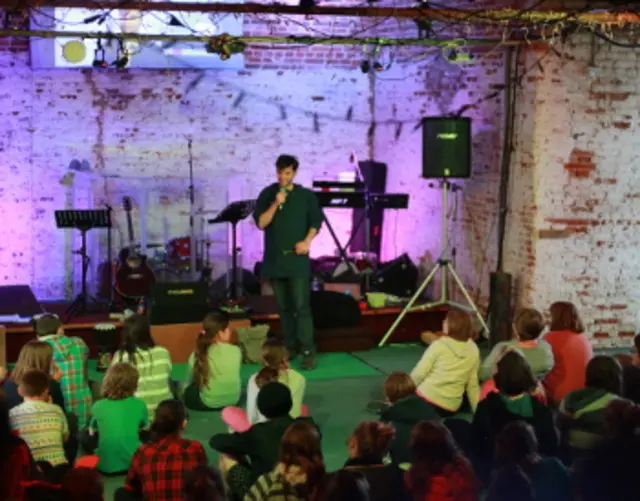 A performer on stage, with audience