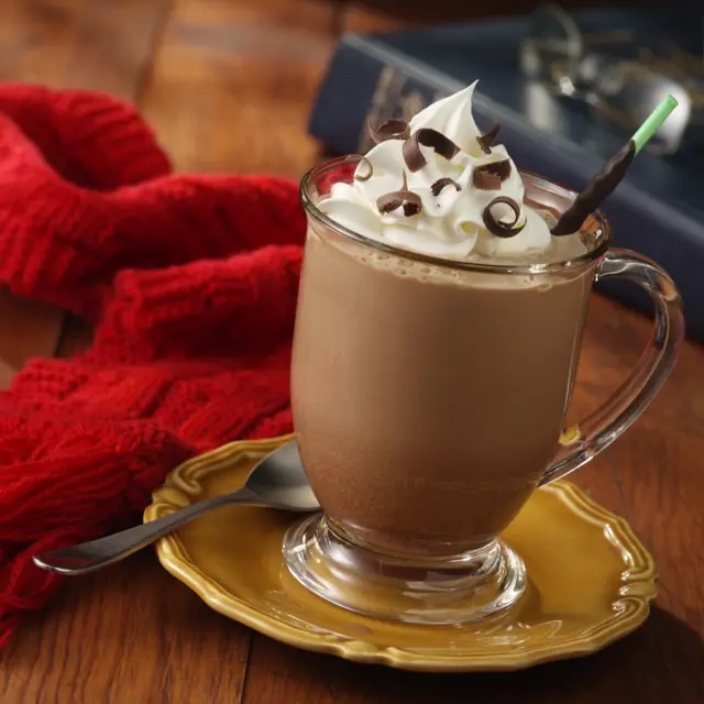 A hot chocolate drink with a cream topping