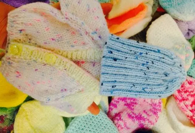 A pile of tiny knitted garments