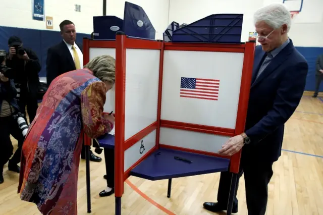 Democratic US presidential candidate Hillary Clinton and her husband, former US President Bill Clinton, fill out their ballots in the New York presidential primary election at the Grafflin School in Chappaqua, New York, 19 April 2016