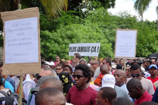 People take part in a march on April 19, 2016 in Mamoutzou to denounce violence and insecurity in the island, as part of a citizen mobilization called 'Ile Morte' (Dead Island). The march was called in response to the April 15 killing of a man by unknown attackers while on his way to collect his children.