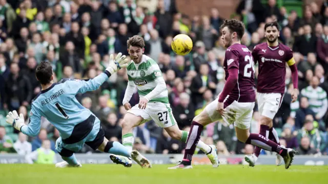 Patrick Roberts clips the ball over Neil Alexander to put Celtic in front.