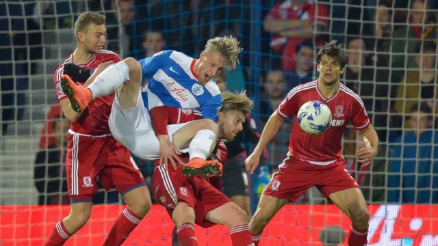 QPR's Sebastian Polter is lifter in the air by Middlesbrough's Adam Clayton