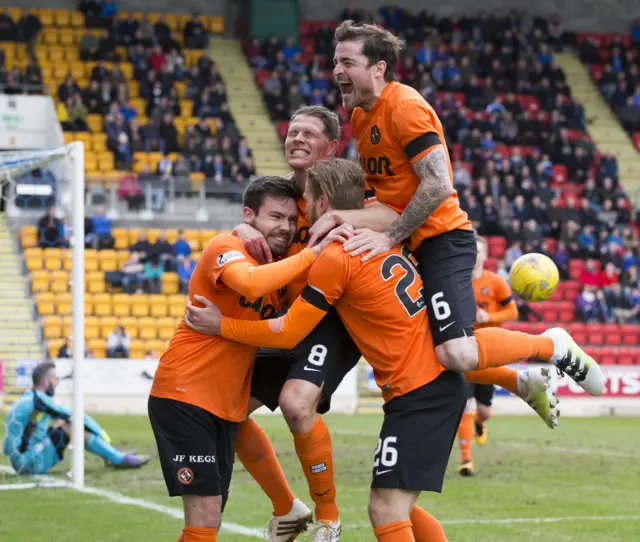 The United players celebrate Ryan Dow's goal at McDiarmid Park, while Saints goalie Alan Mannus contemplates his error.