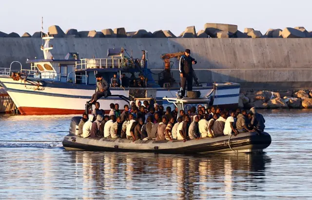 Sub-Saharan African migrants are rescued by the Libyan coastguard after their inflatable boat started to sink off the coastal town of Guarabouli, 60 kilometres east of the capital Tripoli on November 20, 2014