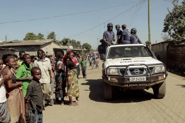 Zambian Police patrol near the Chawama Compound where residents have attacked broken and looted foreign-run shops in Lusaka on April 19, 2016