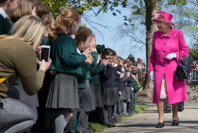 The Queen is greeted by schoolchildren at Alexandra Gardens