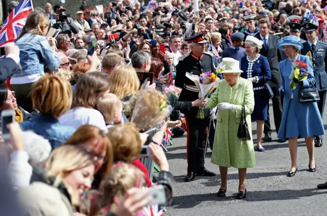 Queen is handed flowers from wellwishers