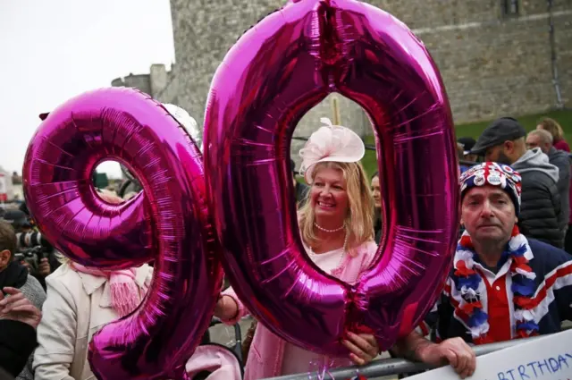 Royal well-wishers with a big balloon saying 90