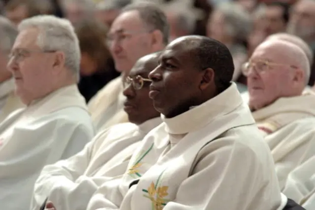 A picture taken on January 29, 2006 shows Rwandan priest Wenceslas Munyeshyaka (C, foreground) attending a mass in Evreux, western France