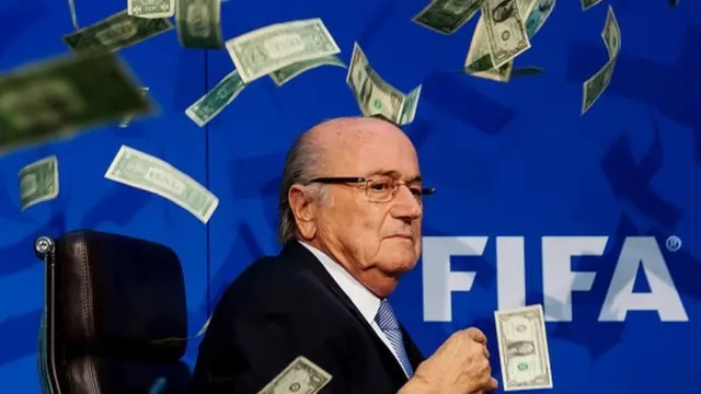 Comedian Simon Brodkin (not pictured) throws dollar bills at FIFA President Joseph S. Blatter during a press conference at the Extraordinary FIFA Executive Committee Meeting at the FIFA headquarters on July 20, 2015 in Zurich, Switzerland