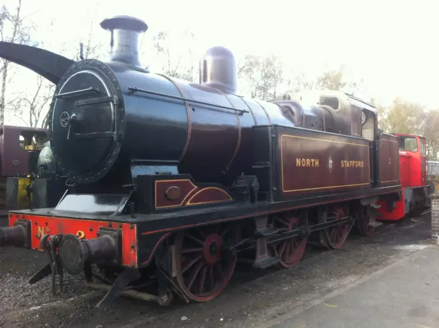 Classic locomotive sitting on gravel