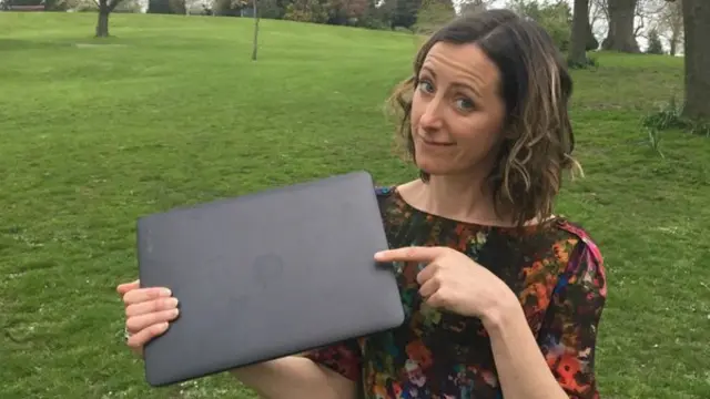 Natalie Fee holding a laptop