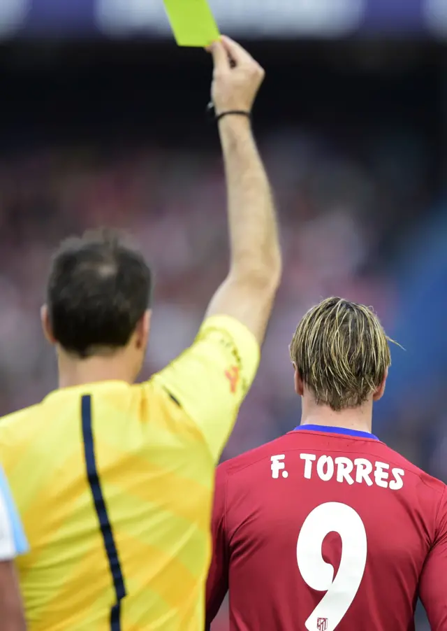 Fernando Torres is shown a yellow card