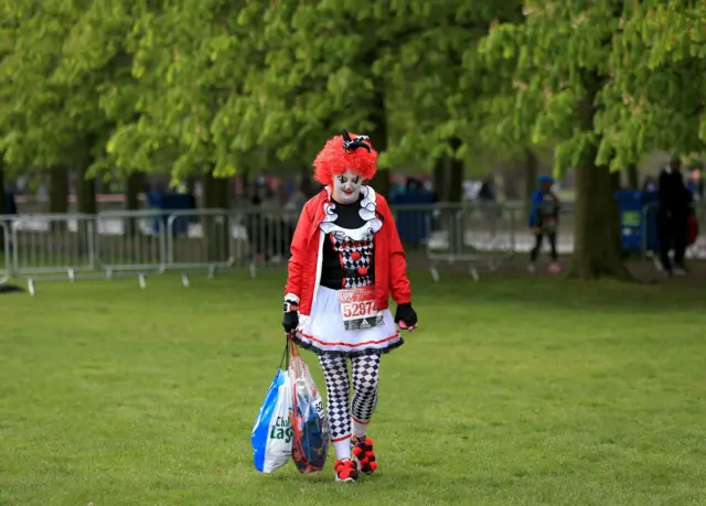 A participant in fancy dress prepares for the start of the race before the London Marathon