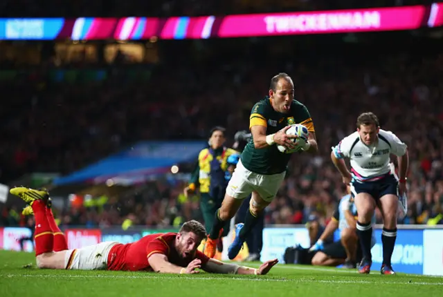 : Fourie Du Preez of South Africa scores a try despite the diving tackle of Alex Cuthbert of Wales during the 2015 Rugby World Cup Quarter Final match between South Africa and Wales at Twickenham Stadium on October 17, 2015 in London