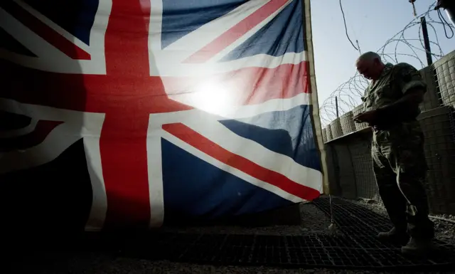 A Union Jack with a soldier next to it