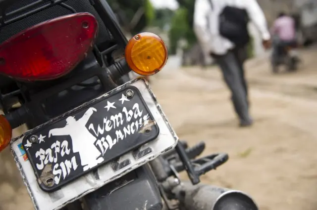 A picture taken on April 25, 2016 shows the plate of a moto in tribute to Congolese world music legend, renowned as the "king of Congolese rumba", Papa Wemba, in Mbinza, near Kinshasa.