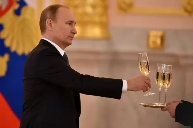 President Putin getting a glass of champagne