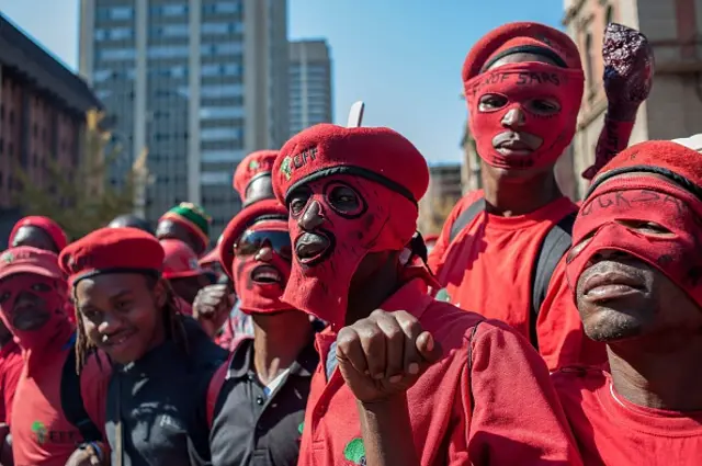 upporters of South Africa's opposition Economic Freedom Fighters (EFF) demonstrate outside the Gauteng North High Court in Pretoria on June 1, 2015 in support of EFF leader Julius Malema as he faces charges of tax evasion brought against him by the South African Revenue Service (SARS)